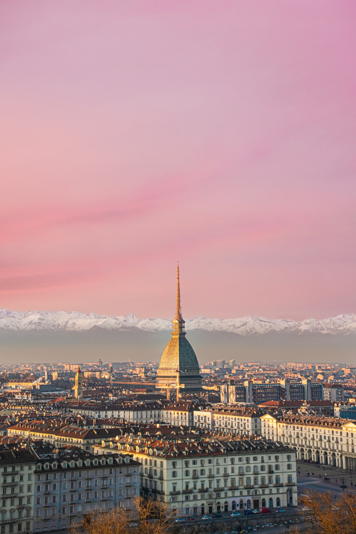 Turin skyline with the Mole Antonelliana and snow-capped Alps at sunset