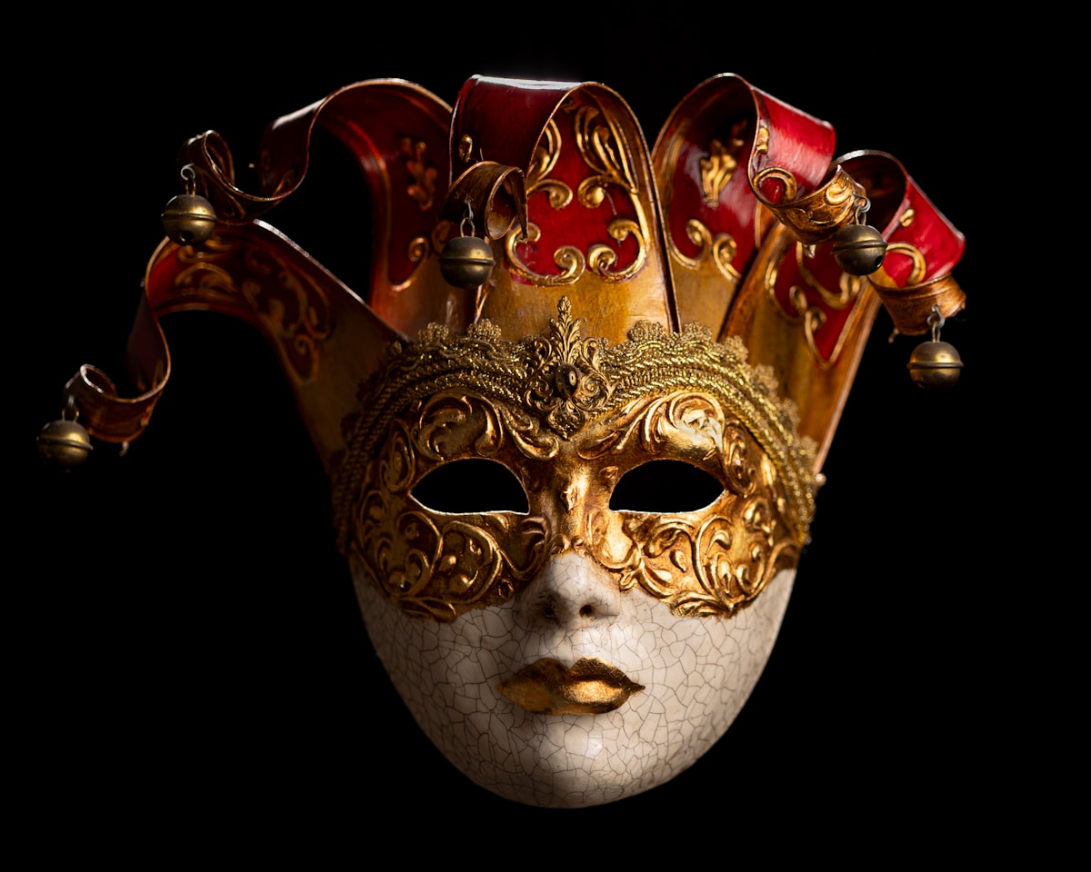Elaborately costumed figure in a Venetian mask and ornate outfit at Venice Carnival
