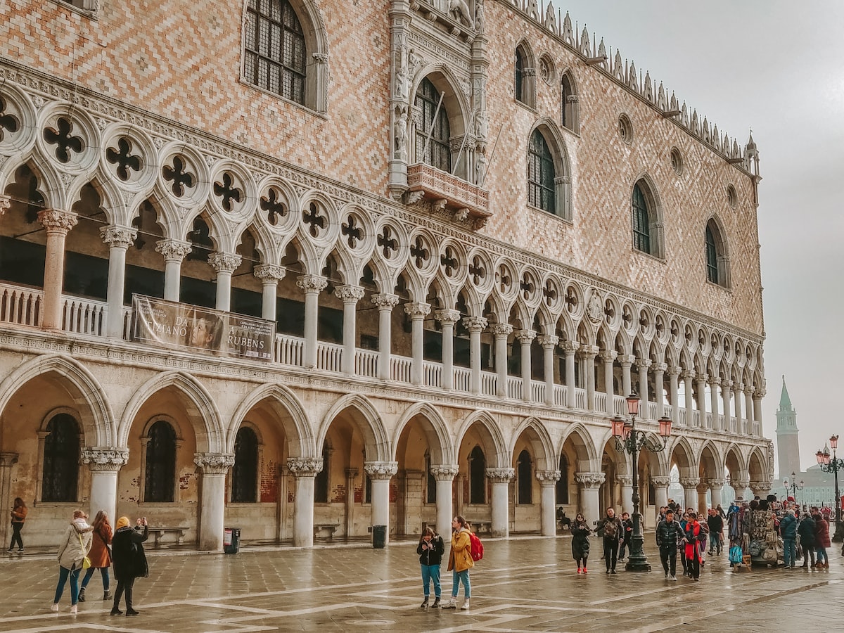 The Gothic facade of the Doge's Palace on St Mark's Square, Venice, with crowds outside