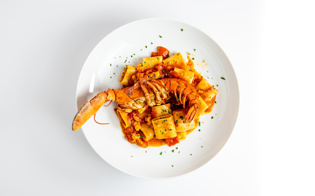 Rigatoni with whole lobster in tomato sauce, Venetian seafood pasta