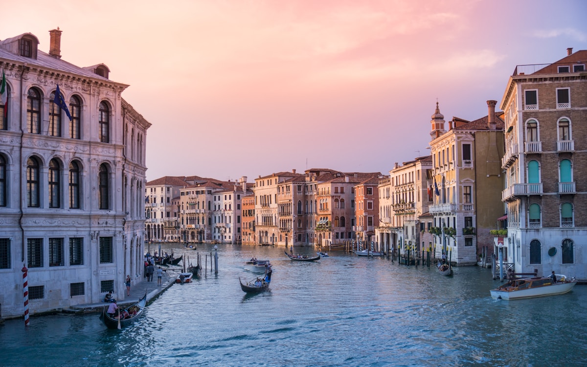 Gondolas on body of water at Rialto Bridge, Venice, Italy