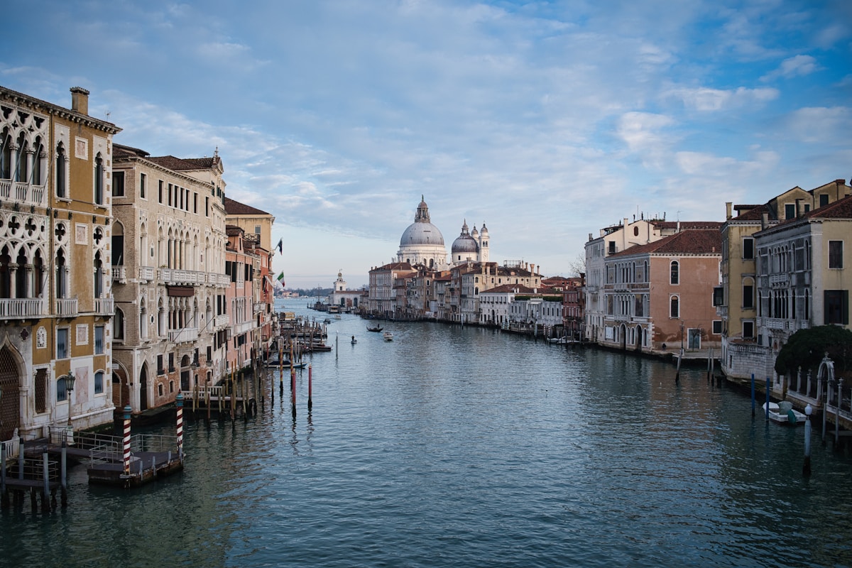 Venice canal with historic buildings and dome, Italy
