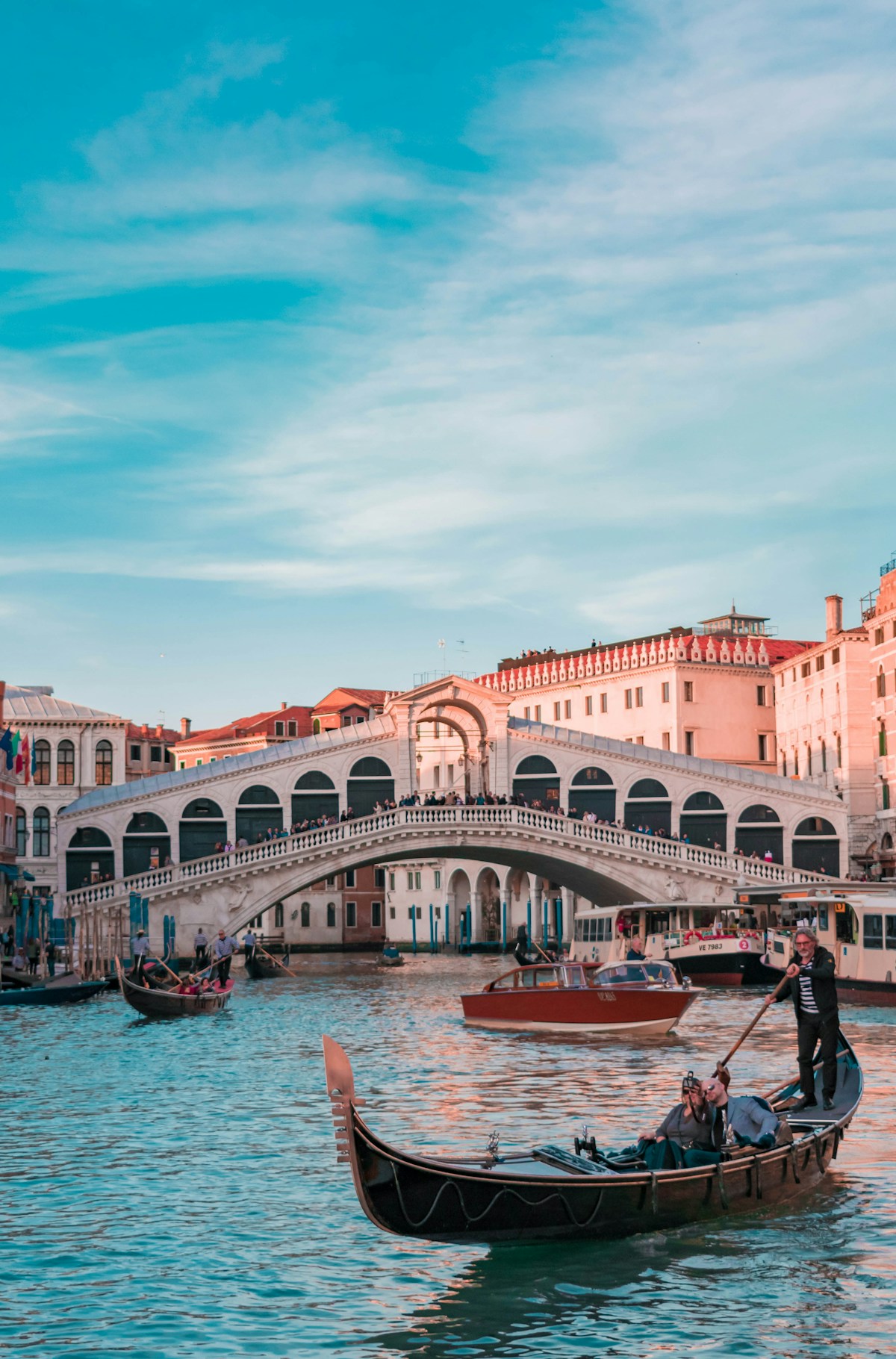 Gondola on the Grand Canal passing the Rialto Bridge, Venice, Italy